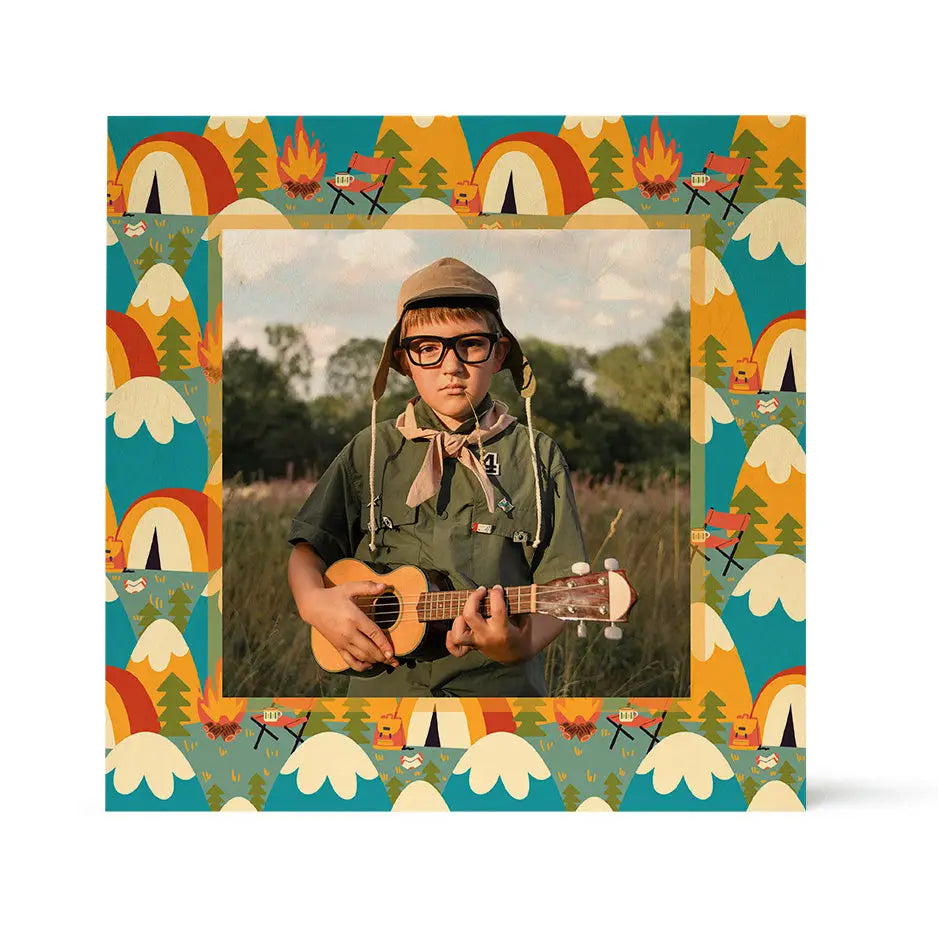 "Camping pattern wood print featuring whimsical designs of bears, tents, mountains, and campfires printed on rustic birch wood."
