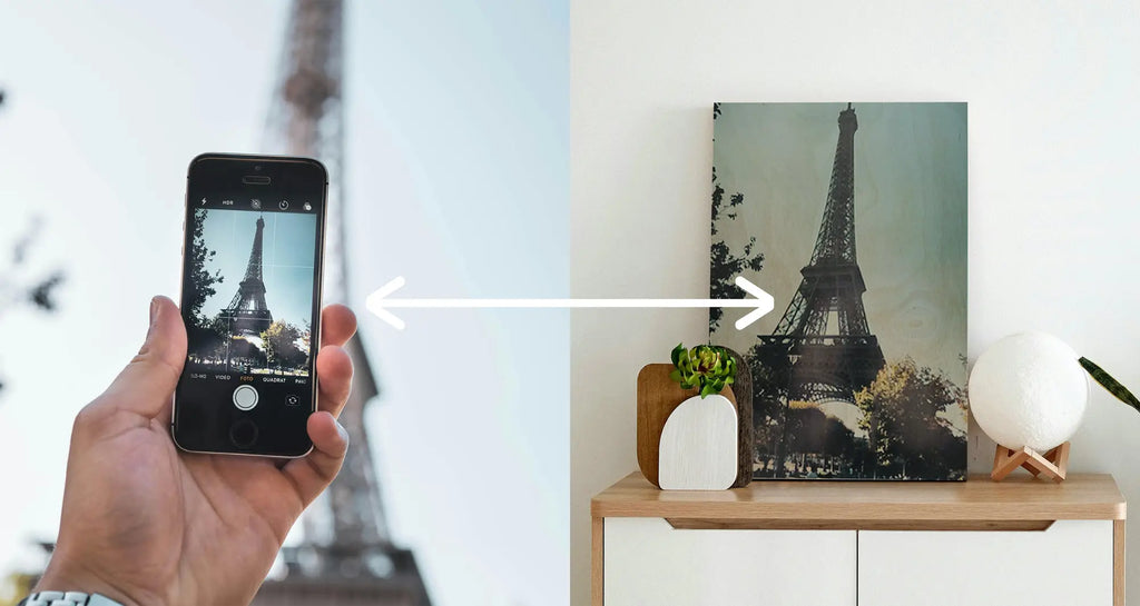 Eiffel Tower on a smartphone screen and wood printing photograph displayed together.