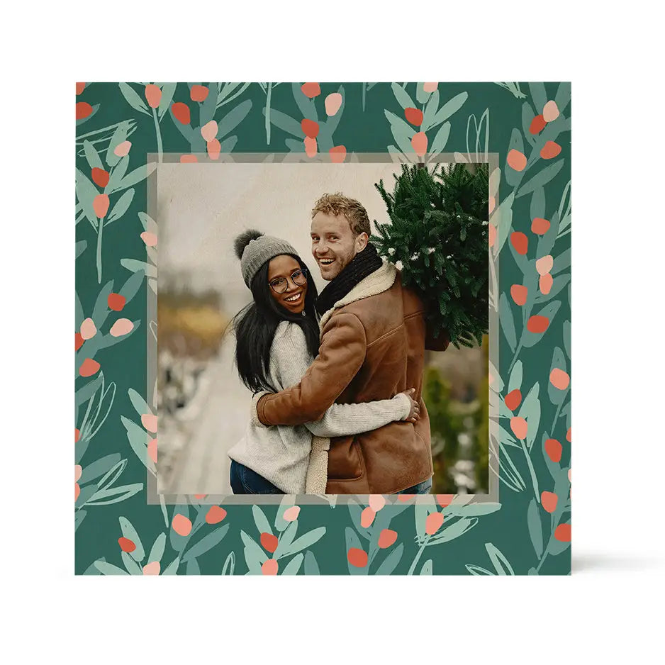 Framed photograph of a couple with a Christmas tree in Woodsnap’s birch pattern border