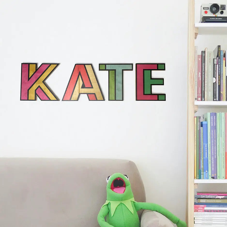 Colorful block letters spelling KATE on a wall in 10’’ Wood Letters - Double Color