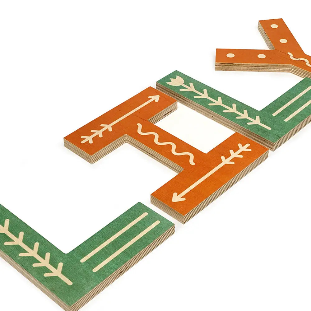 Wooden puzzle pieces with arrow and leaf designs in orange and green colors.