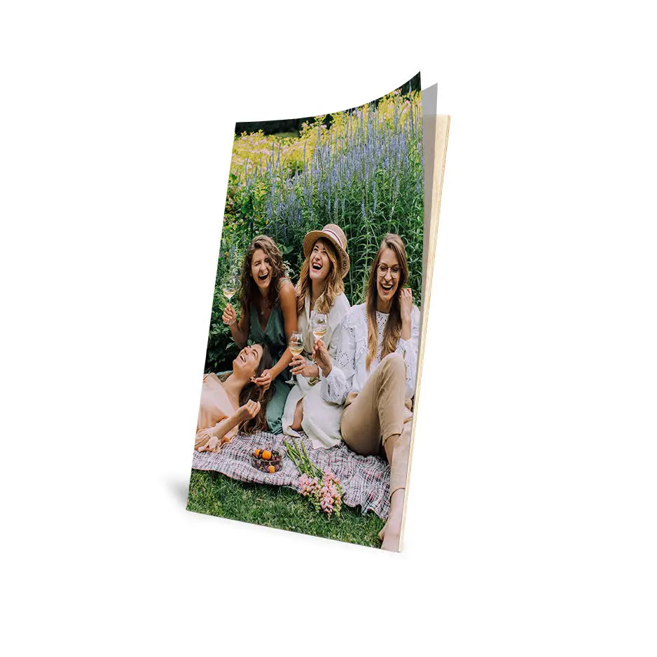 Woman and two girls enjoying a 10x24 Cove Photo Mount Print on the grass