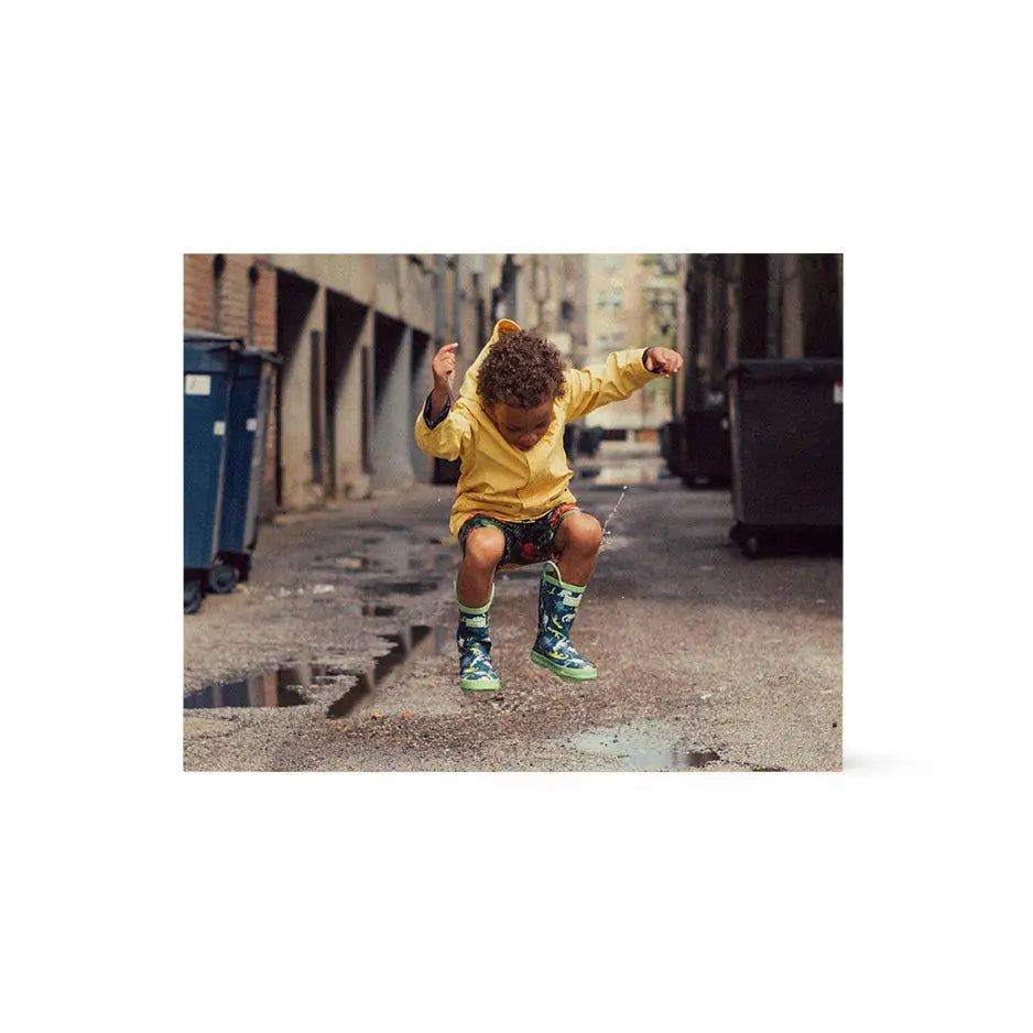 Young boy in yellow shirt and green pants on street, featured in 11x14 wood print