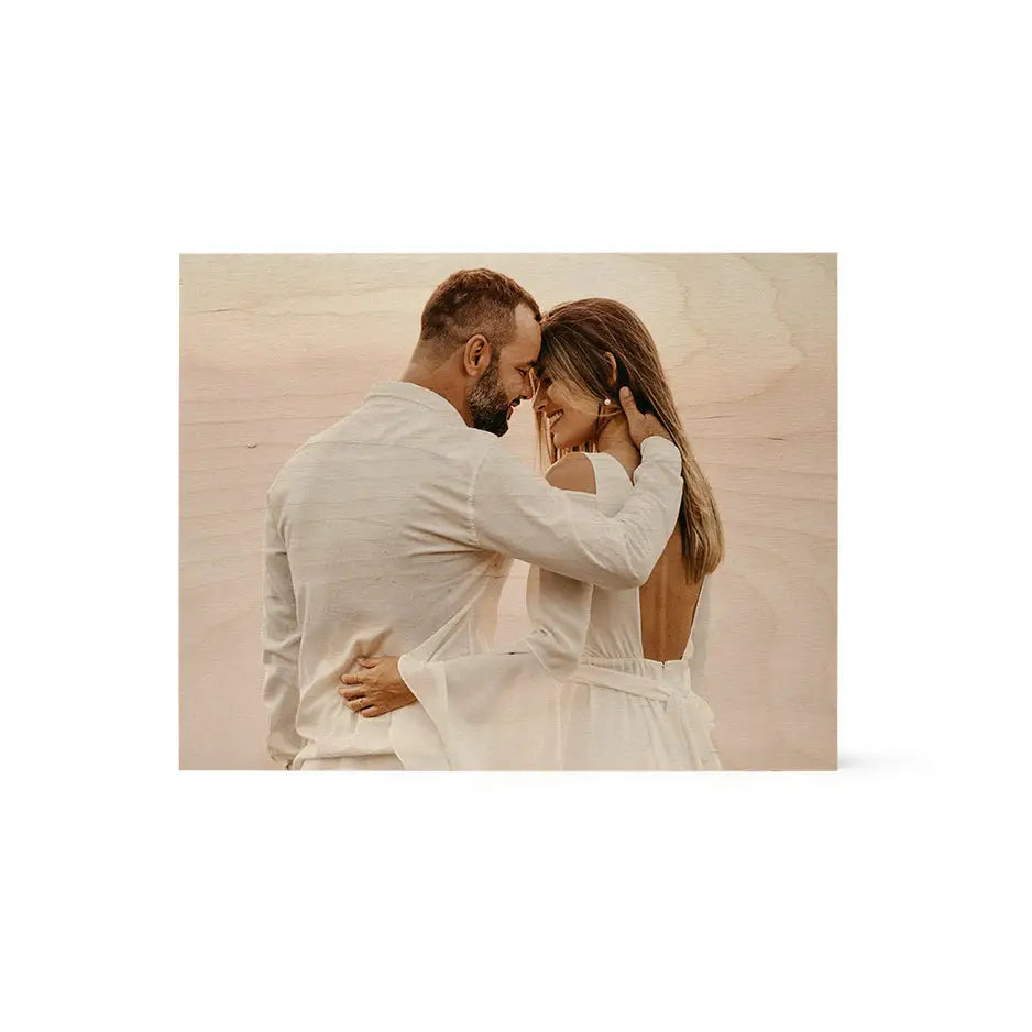 A man and woman in white clothes embracing on an 11x14 wood print vintage