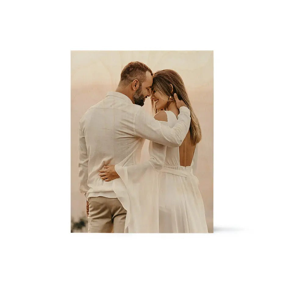 A man and woman in white suits embracing on an 11x14 wood print vintage