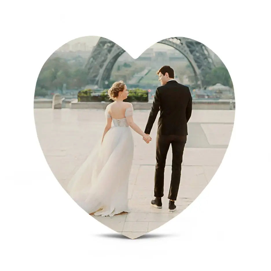 Couple holding hands in front of a 12 Inch Heart Wood Print showcasing love