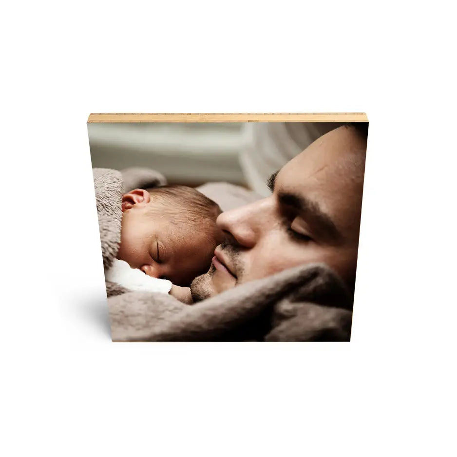 Man holding a baby on 12x12 Bamboo Wood Print for a heartwarming display