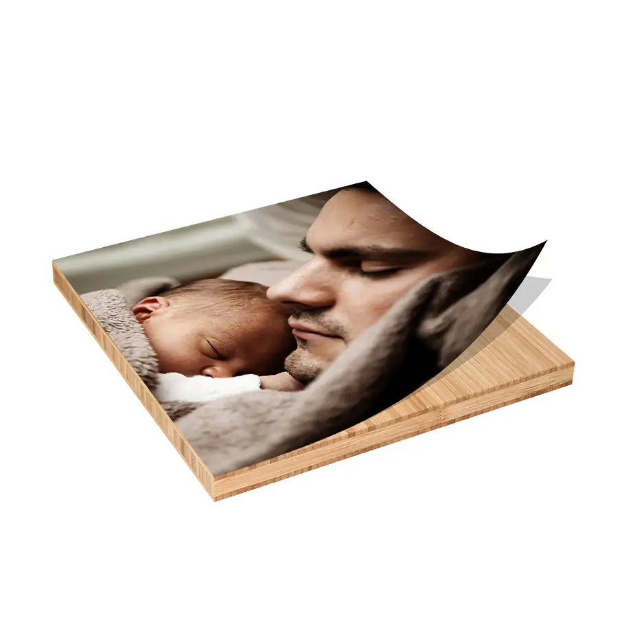 Wooden photo coaster featuring a man holding a baby on 12x12 Bamboo Wood Print