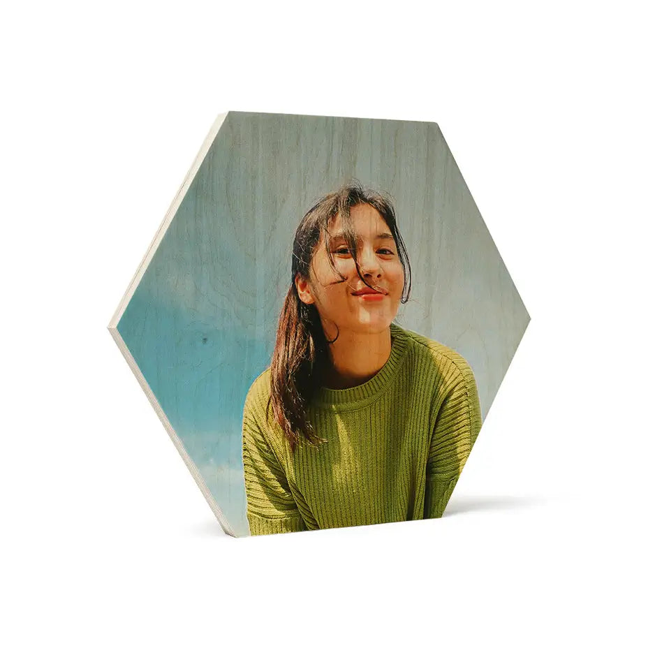 Woman in a green sweater gazes up beside a 12x12 hexagon wood print vintage design