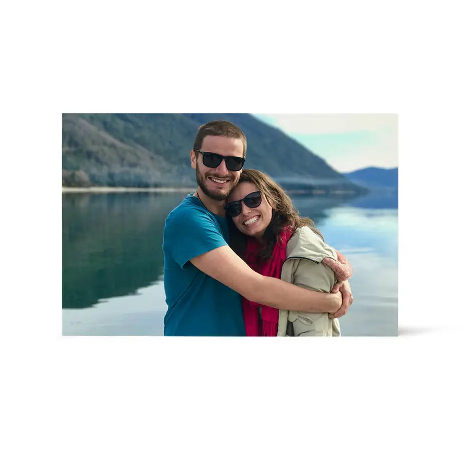 A man and woman hugging on a boat in a 12x18 wood print bright white design