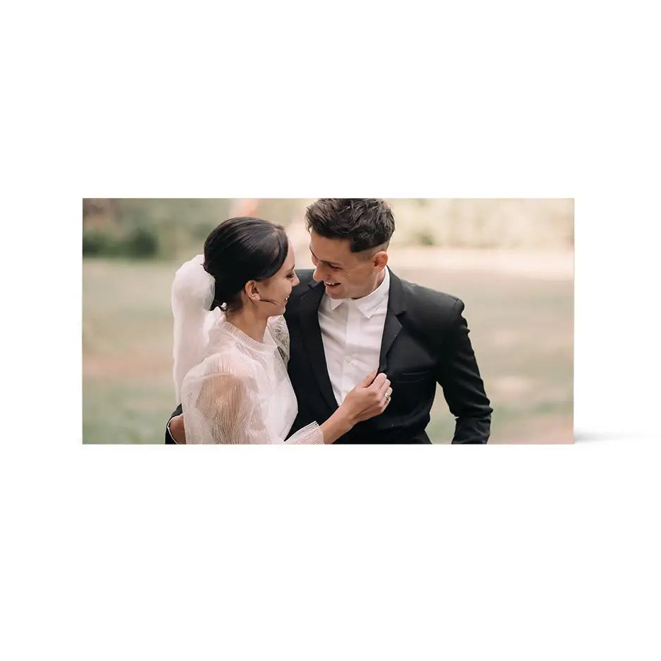 Bride and groom in a field captured in a 12x24 Birch photo mount print