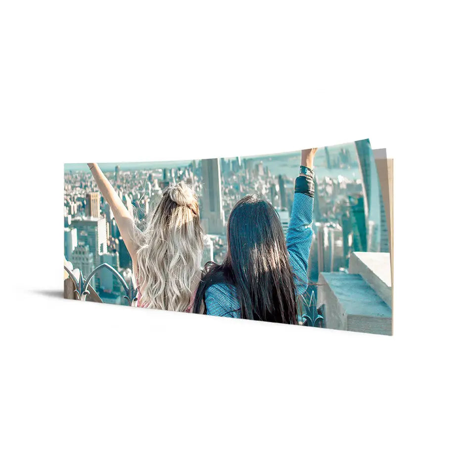 Two women enjoy a view from a building in a 12x36 Cove Photo Mount Print