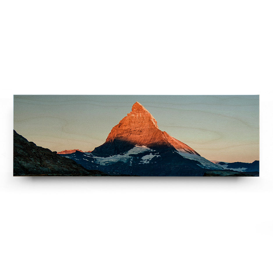 Mountain peak illuminated by sunlight in 12x36 Original Cove Print display