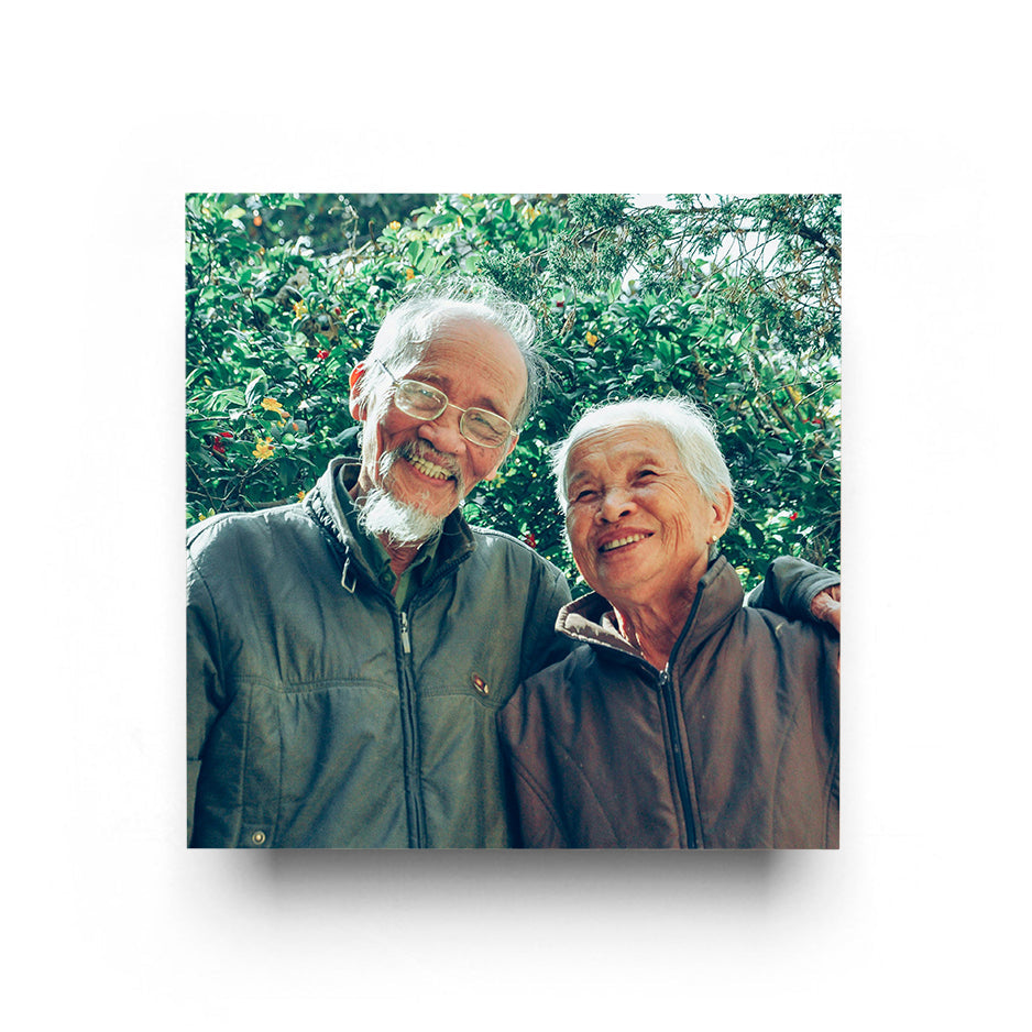 Smiling elderly couple with a 16x16 cove photo mount print for lasting memories