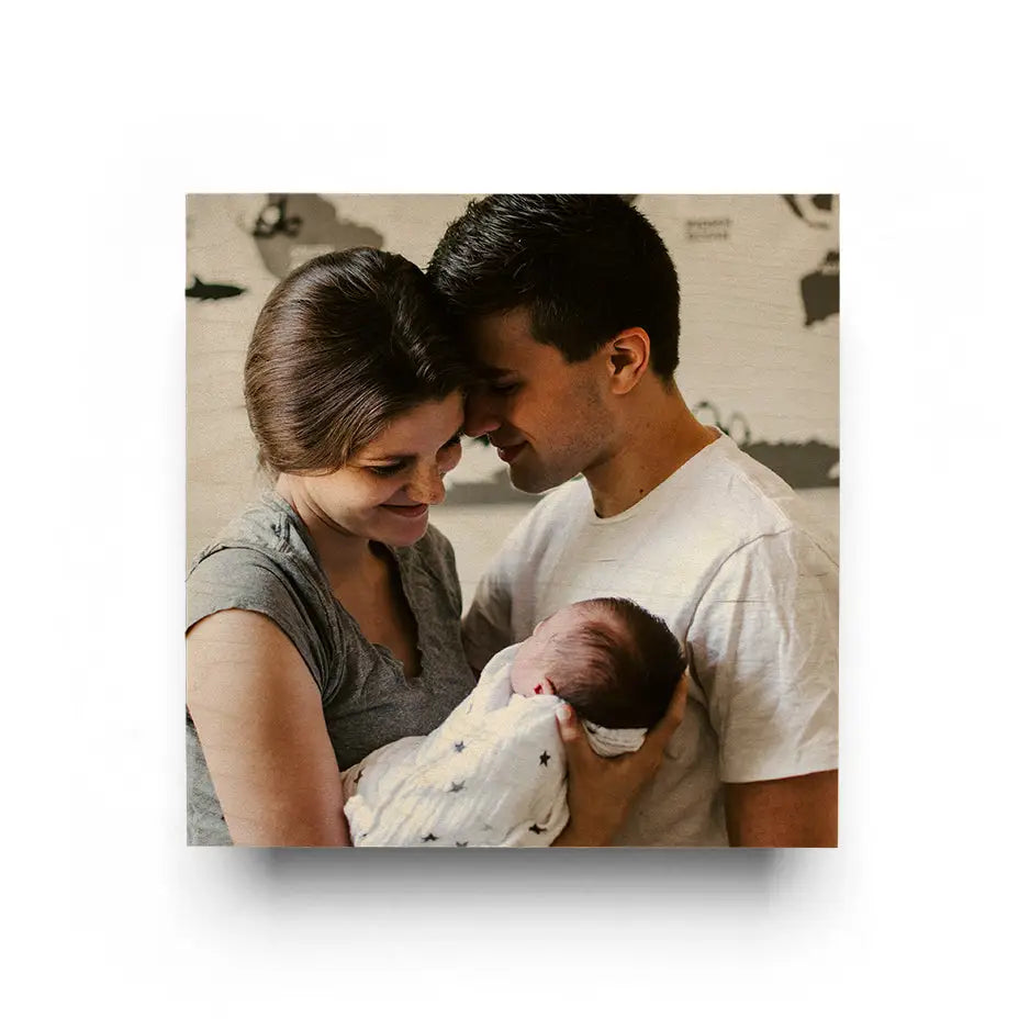 Couple holding a baby in their arms, featured in a 16x16 Original Cove Print