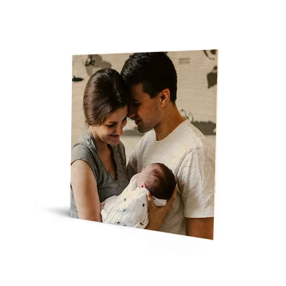 Man holding a baby in a 16x16 Original Cove Print, perfect for photo locket wood