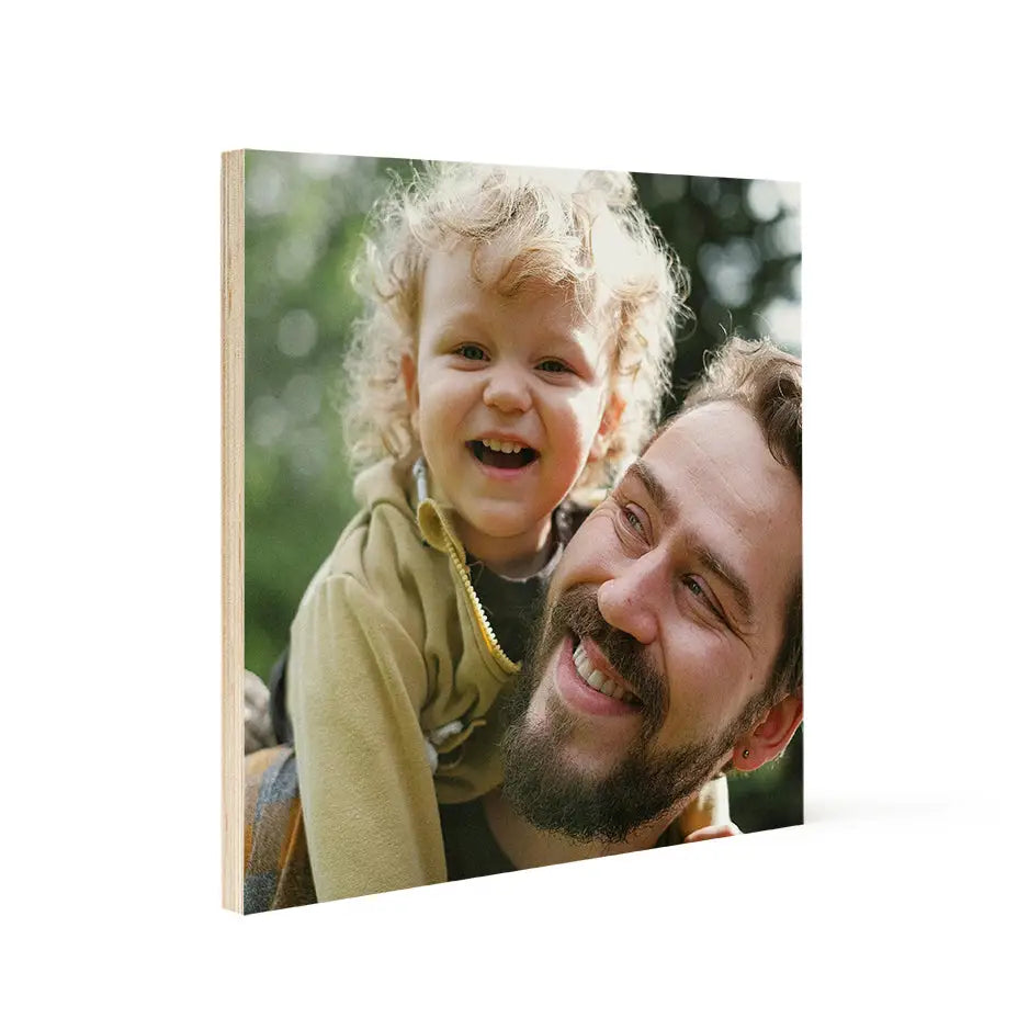 Father holding daughter in arms on a 16x16 wood print bright for heartwarming decor