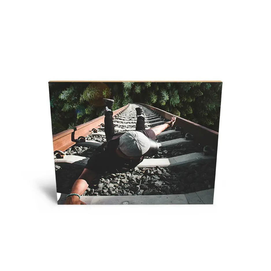 Black and white photo of a man on train tracks on 16x20 bamboo wood print