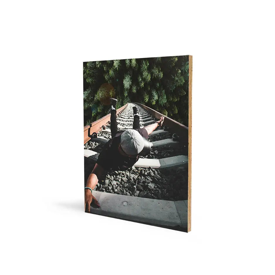 Book with photo of a man on the ground in a 16x20 Bamboo Wood Print display