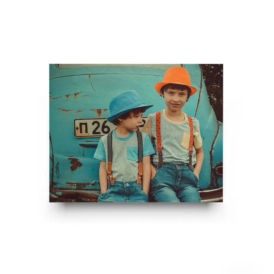 Two children posing in front of a blue truck in a 16x20 Original Cove Print