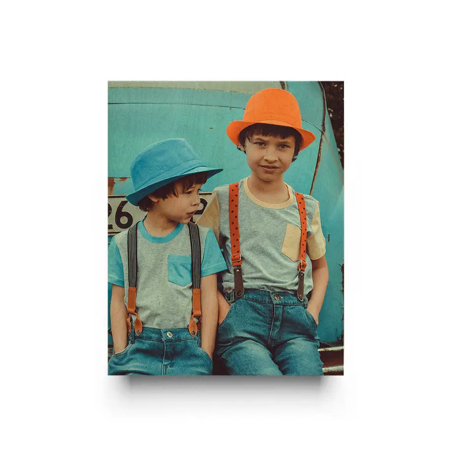 Two young boys in suspenders sitting on a blue truck in a 16x20 Original Cove Print