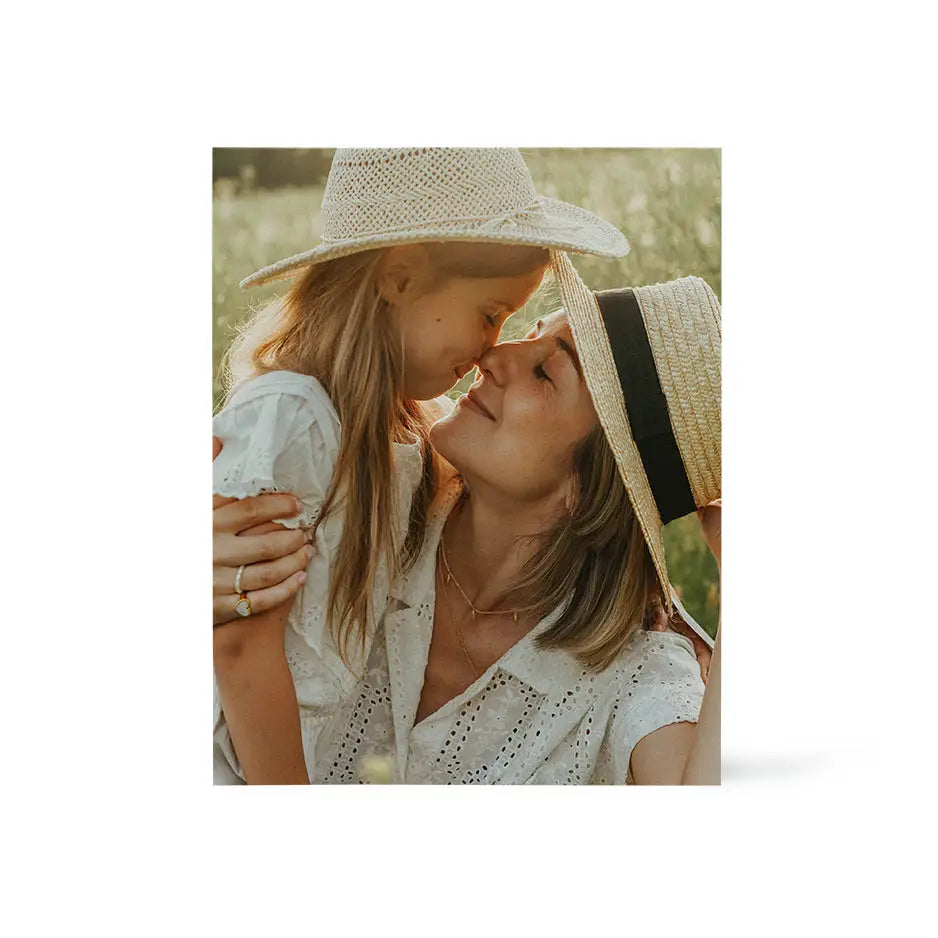 Woman in a straw hat kisses a young girl on a 16x20 wood print bright white