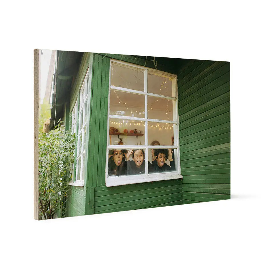 Green wooden building with a white-framed window in a 20x30 wood print design