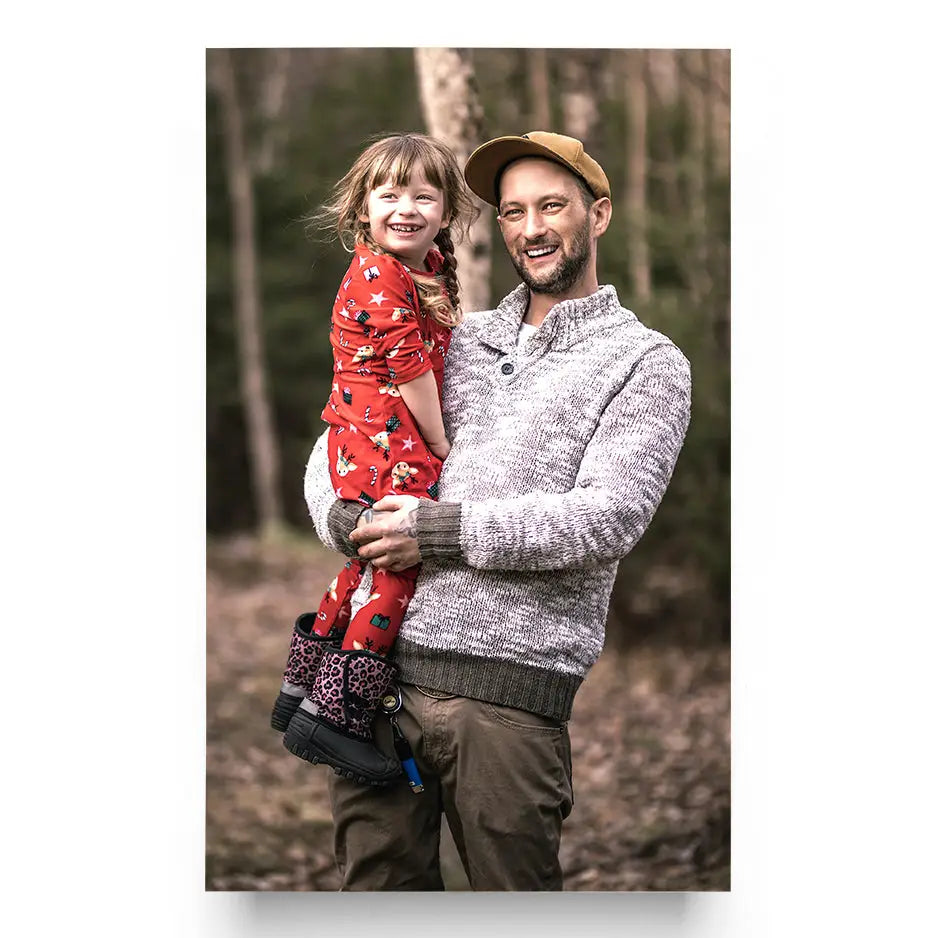 Man holding a little girl in his arms, featured in a 24x36 Cove Photo Mount Print
