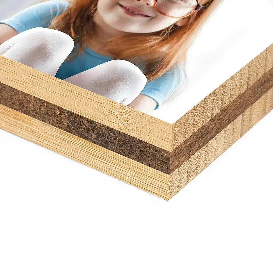 Girl with red hair and glasses posing for a 3x3 bamboo photo block display