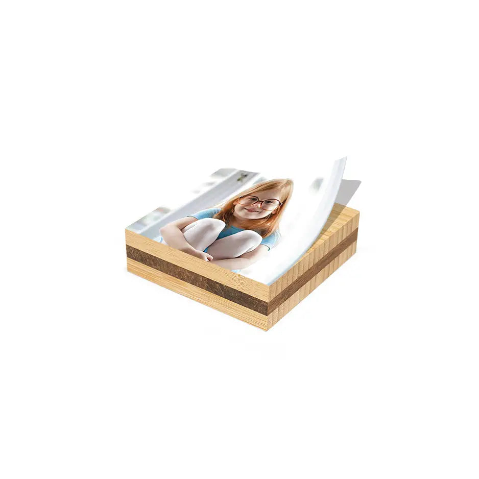 Woman relaxing on a mattress with a 3x3 Bamboo Photo Block nearby