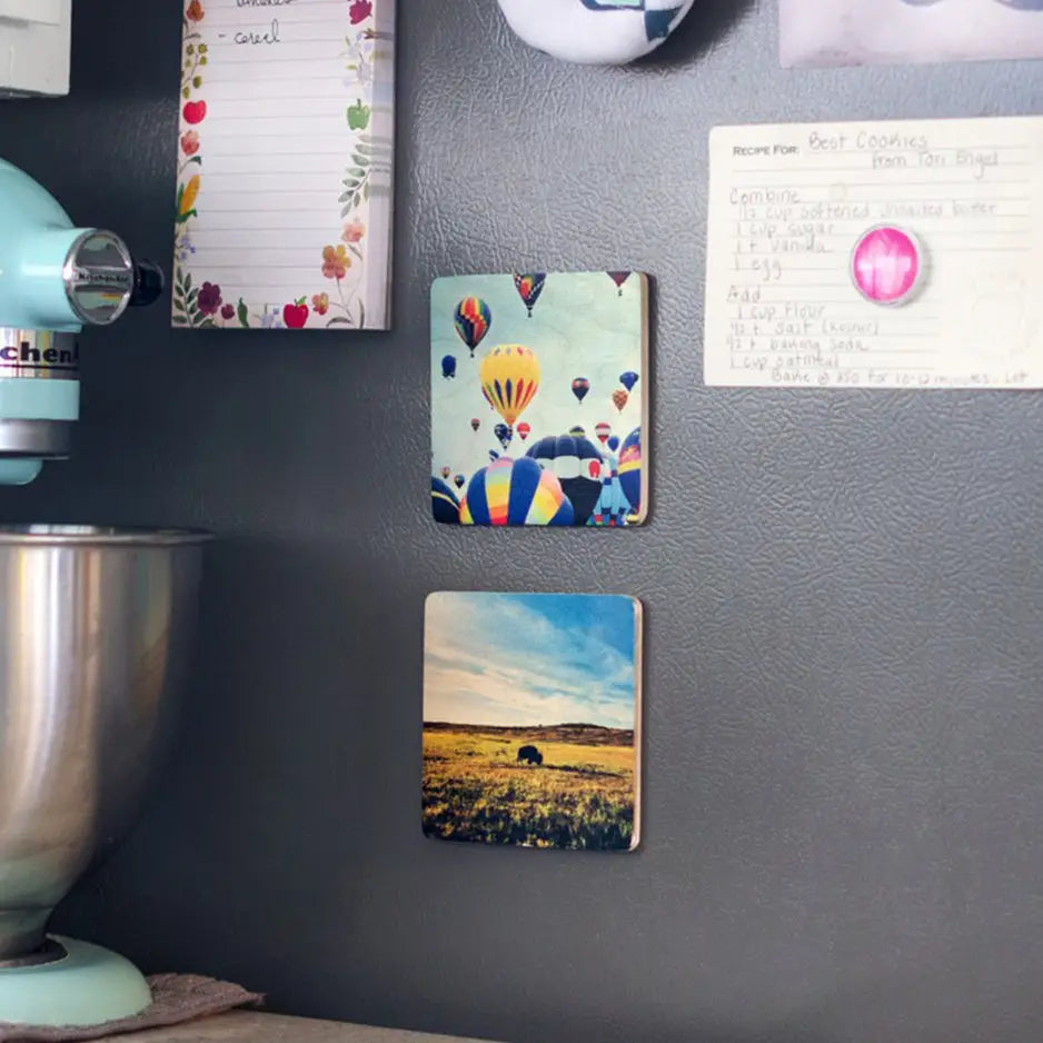 Kitchen wall displaying a 4x4 Square Wood Print Magnet Set with colorful magnets