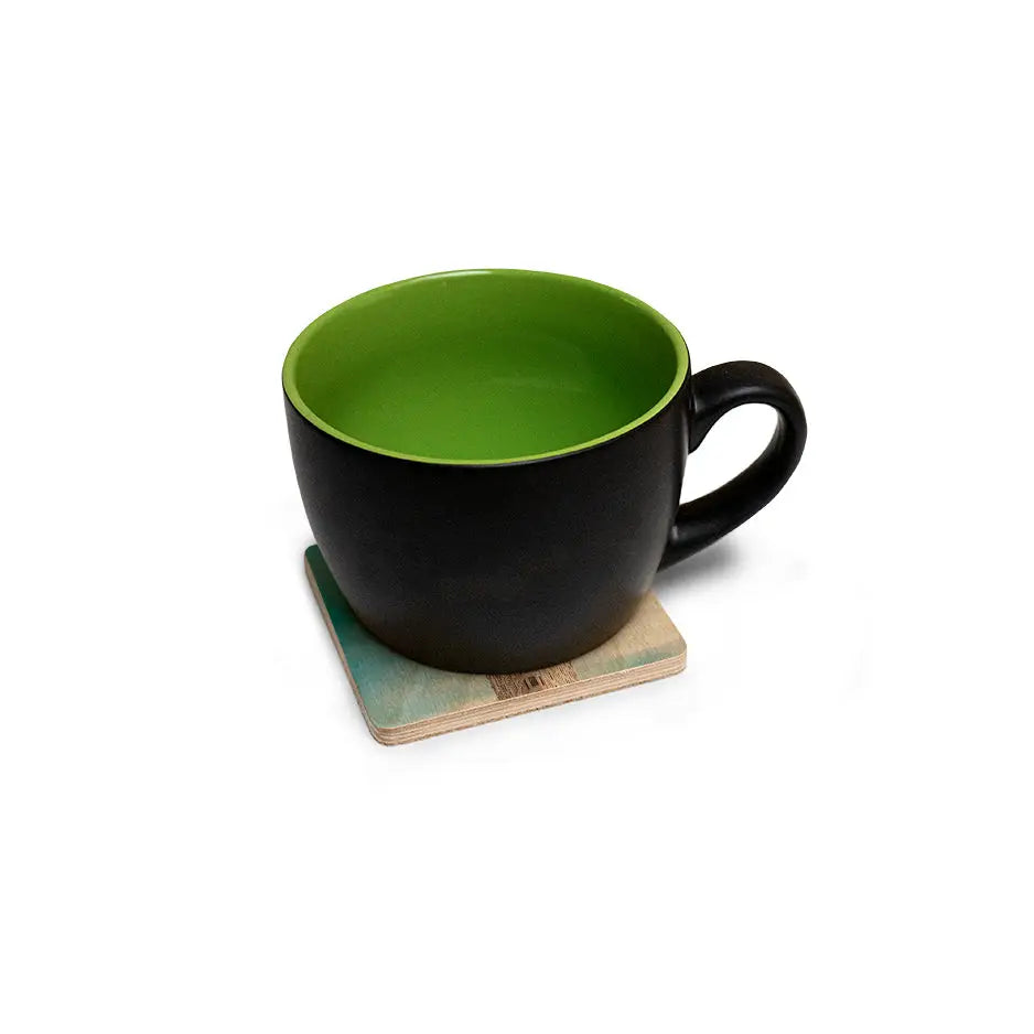 Black and green mug on a 4x4 wood coaster from the Wood Coaster Set