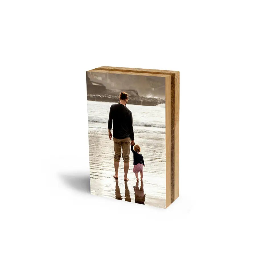 A wooden 5x7 bamboo photo block showcasing a man with his dog on display