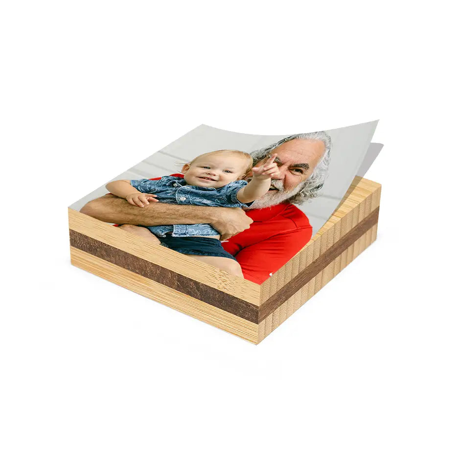 A wooden 6x6 Bamboo Photo Block featuring a man holding a baby
