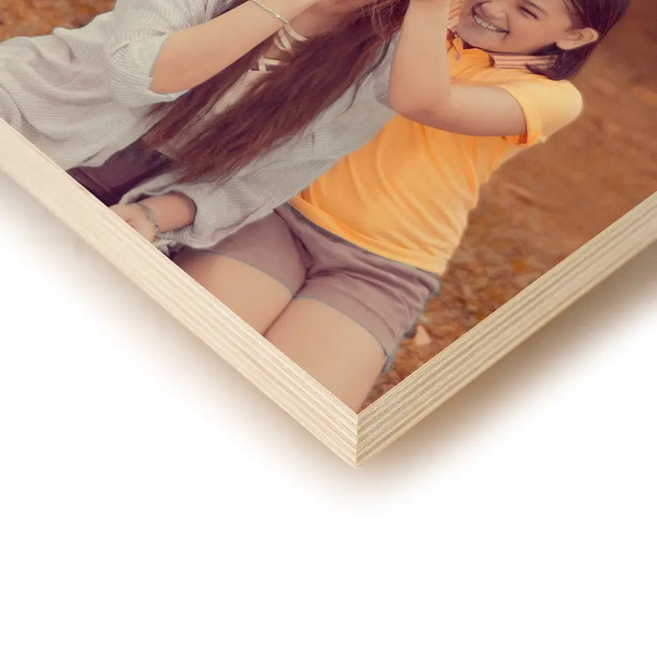 Young girl in a yellow shirt and gray shorts on a 6x6 Birch Photo Mount print