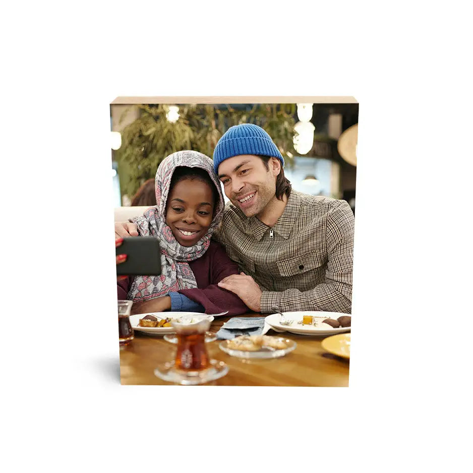 Couple sharing a moment using a tablet beside an 8x10 Maple Photo Block