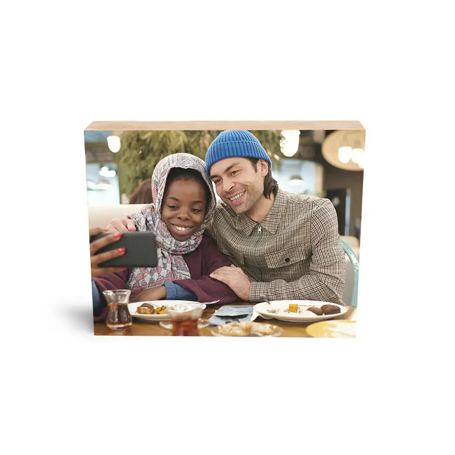 Couple enjoying memories displayed on an 8x10 Maple Photo Block with a tablet