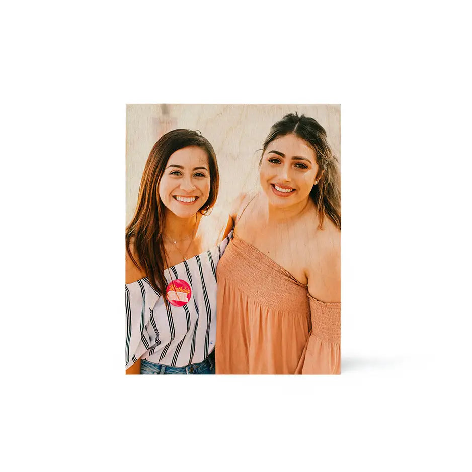 Two women smiling in front of an 8x10 Wood Print Vintage for a joyful moment