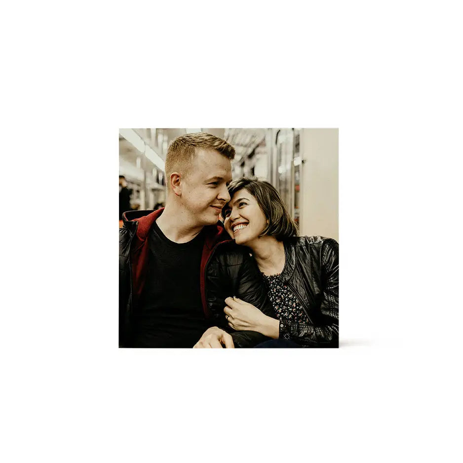 Man and woman smiling and hugging on an 8x8 wood print bright white background