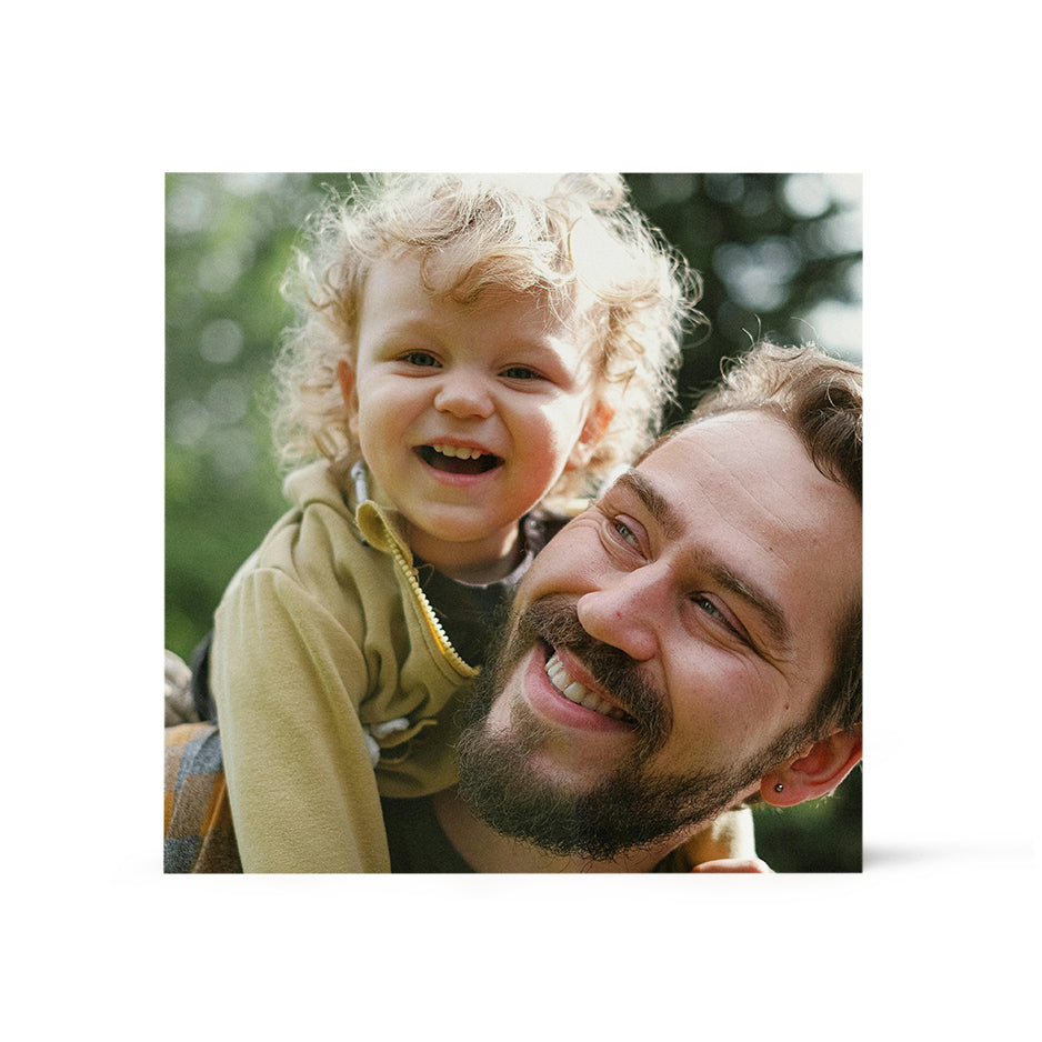 Joyful parent-child moment with curly blonde hair in Birch Bright White Square Prints