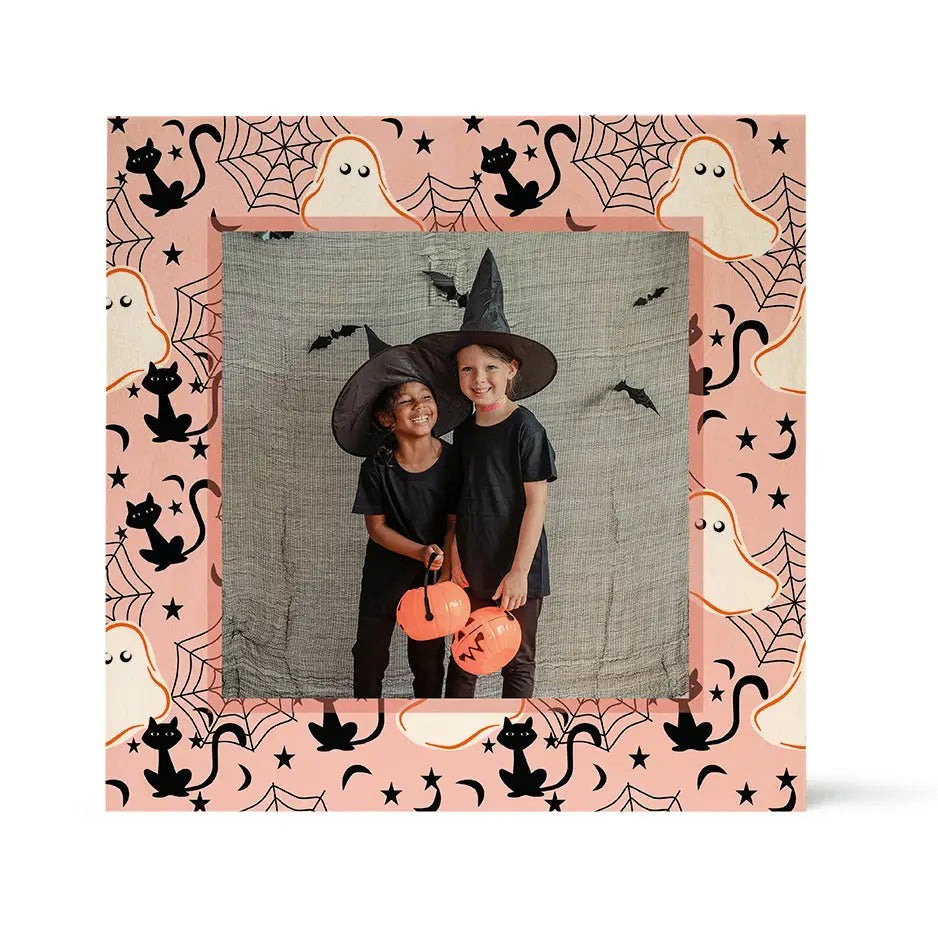 Halloween photo of children in witch hats with a pumpkin bucket and cat ghost design