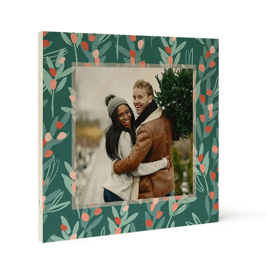 Framed photograph of a couple outdoors with a Christmas Berry Branch birch pattern wood print