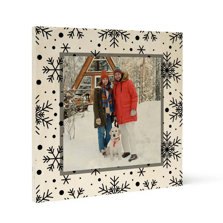 Framed winter photograph of two people in snow with Birch Pattern Wood Print and white snowflake border