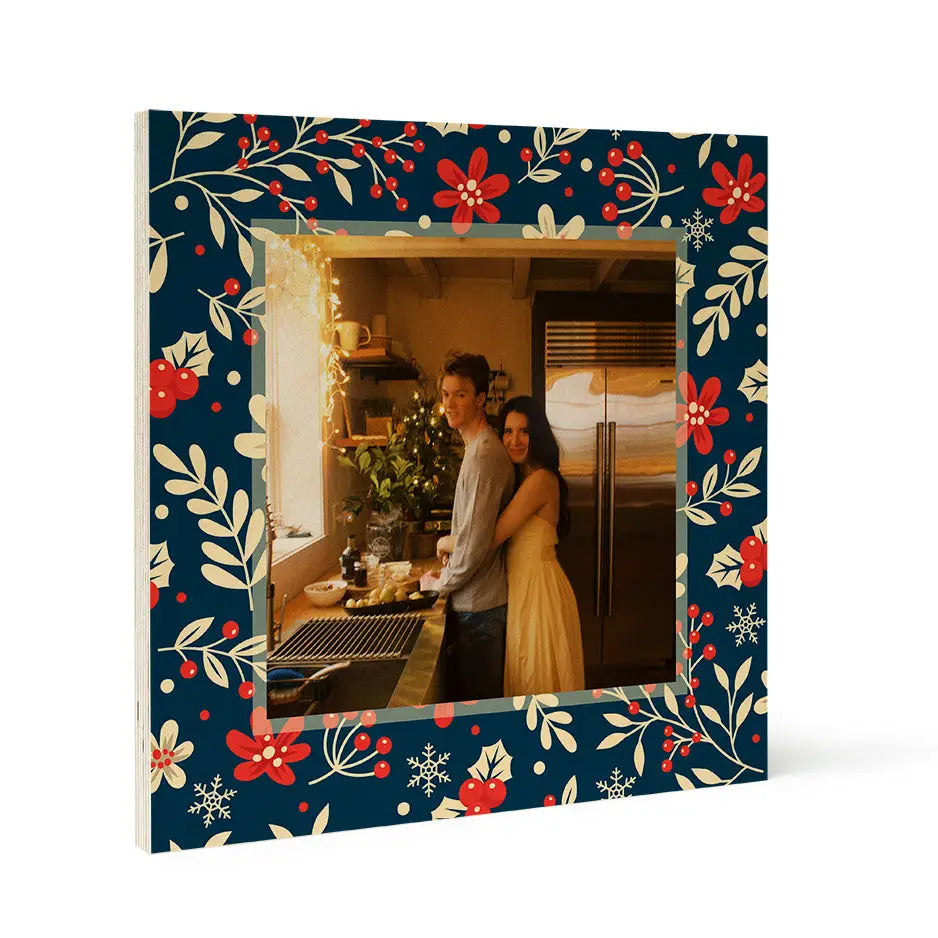 Framed photograph of a couple in a kitchen with birch pattern wood and Christmas mistletoe