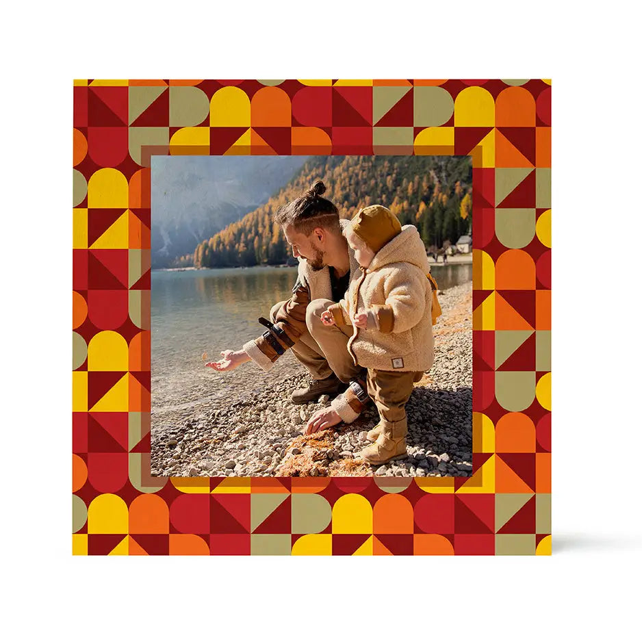 Framed photograph of two people on a rocky lakeshore with Birch Pattern Wood design