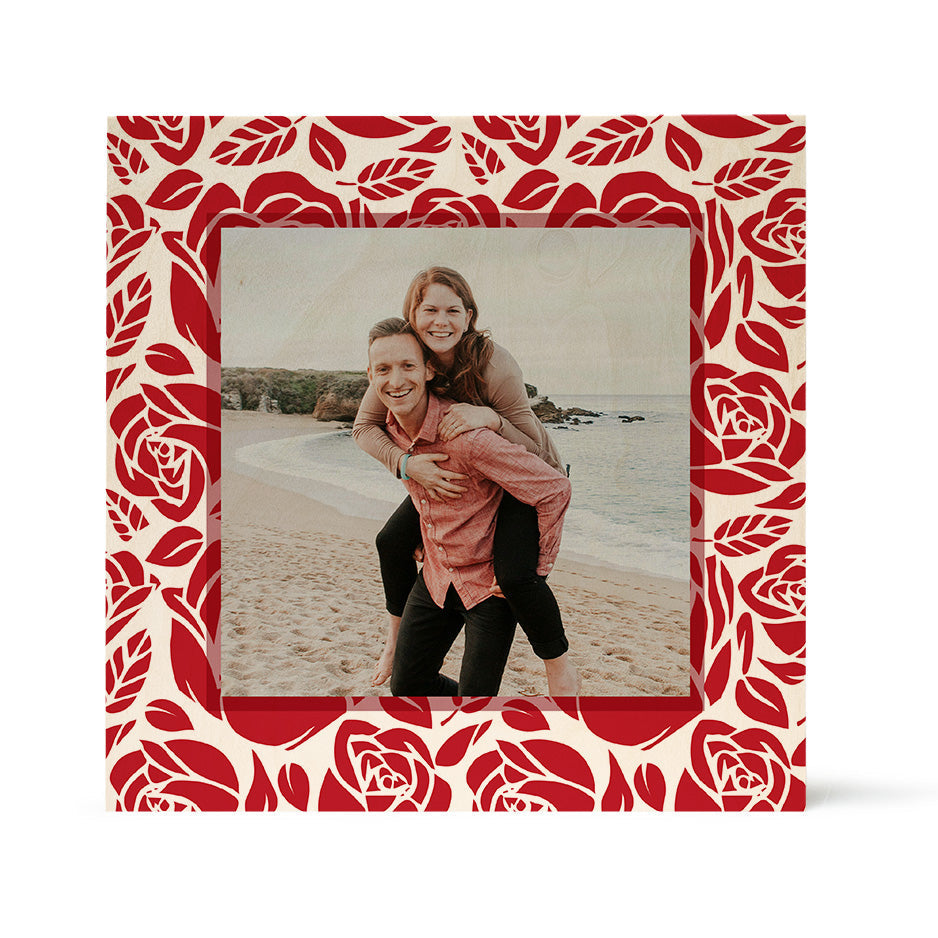 A photograph in a decorative frame featuring the Valentine Red Rose on Birch Pattern Wood