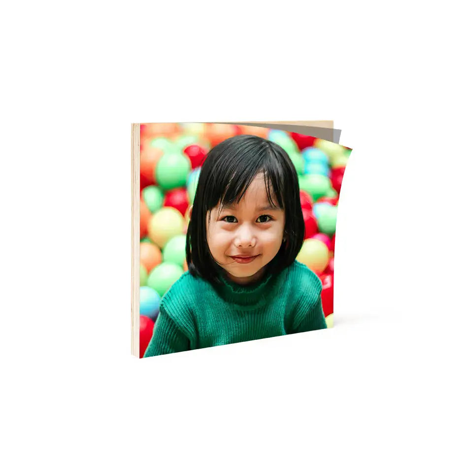 Little girl playing in a ball pit on Birch Photo Mount Square Print wood print