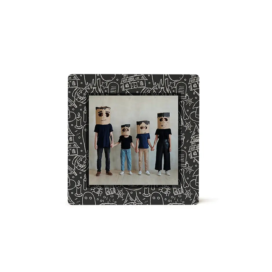 Framed photo tile of four figures with paper bag heads in casual clothing, Chalk Ghost design