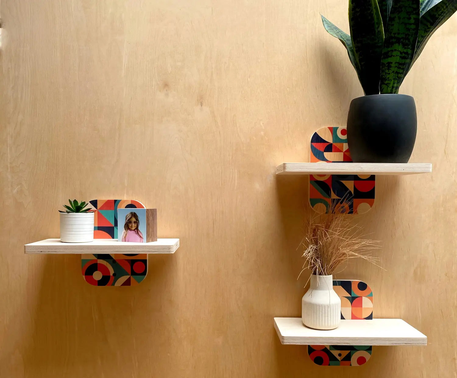 Decorative wooden floating shelves with colorful geometric patterns on Woodsnap’s simple sturdy wall shelf
