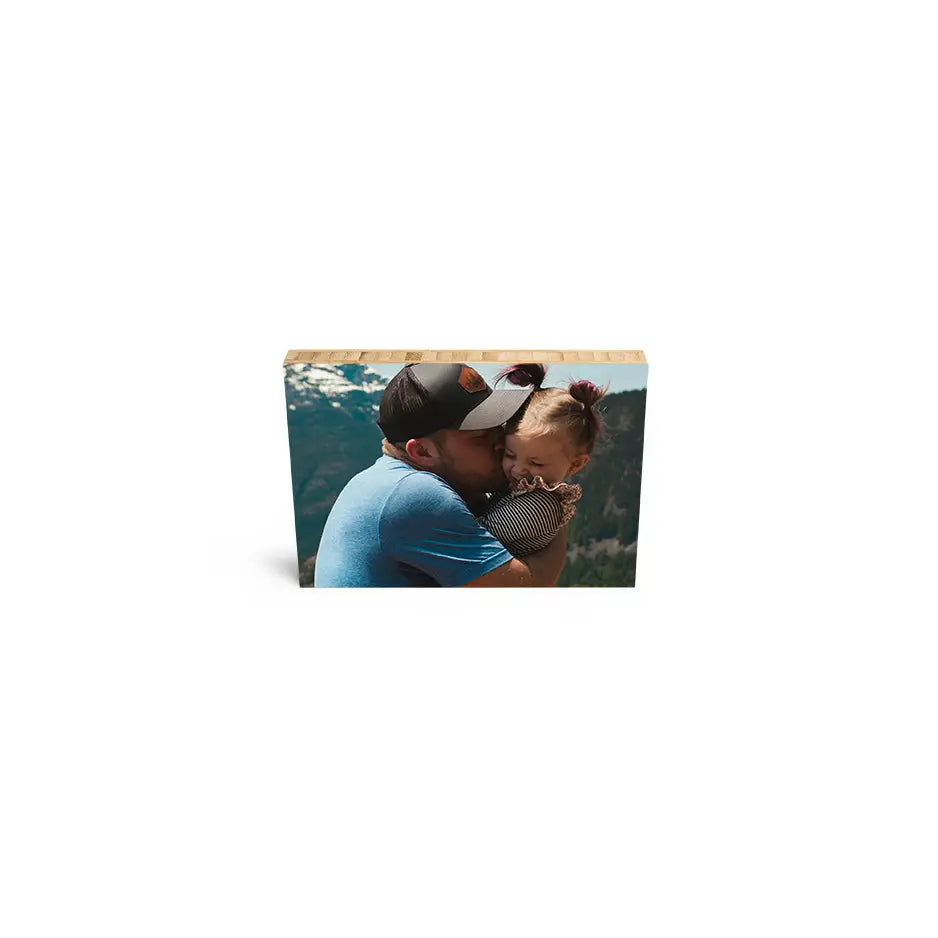 A man and woman kissing in the park on a 5x7 bamboo wood print